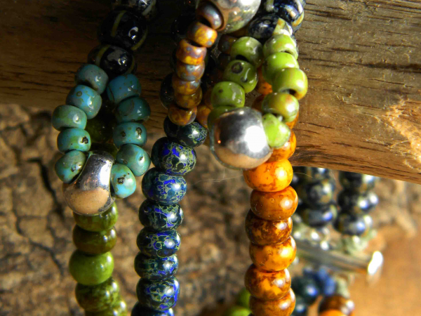 Alternating loop focals in each of 3 strands by Gloria Ewing.