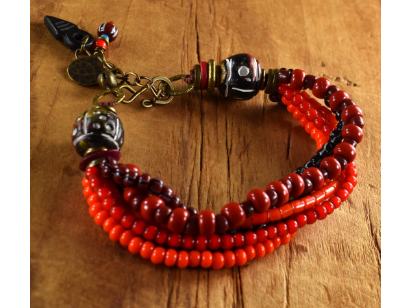 Gorgeous shades of red with black clay beads by Gloria Ewing.