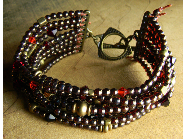 Luscious nine strand brass and crystal design by Gloria Ewing.