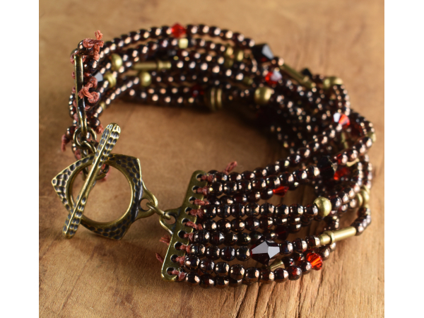Nine strand beaded bracelet with brass from Gloria Ewing.