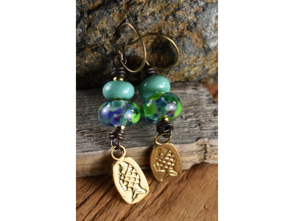 Artisan lampwork glass with fish charms by Gloria Ewing.