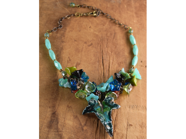 Surrounded by flower beads in a choker by Gloria Ewing.