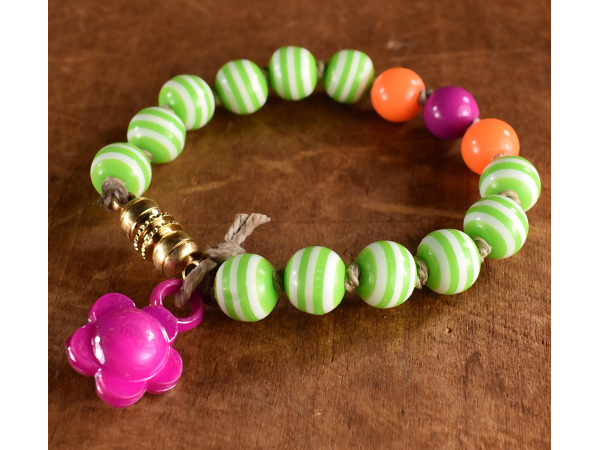 Striped acrylic beaded bracelet with flower charm by Gloria Ewing.