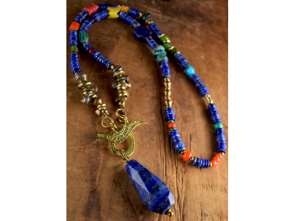 Colorful blend of lapis and coral with brass by Gloria Ewing.