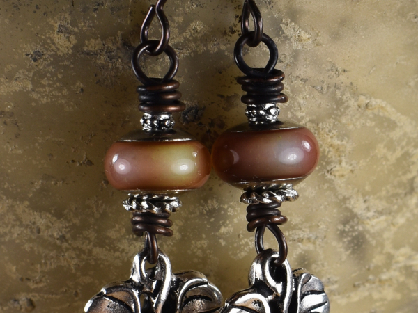 Pewter leaf charms and mood beads in earrings by Gloria Ewing.