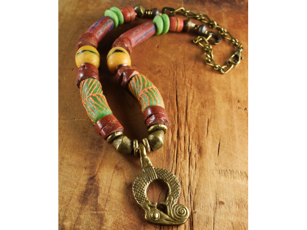 Bright colored Krobo beads with brass pendant, design by Gloria Ewing.