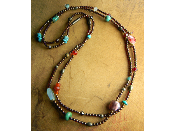 Tiny knotted beads in a long elegant design by Gloria Ewing.