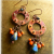 Orange patinaed copper hoop earrings by Gloria Ewing.