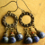 Artisan Bronze Chandelier Earrings Knobby hoops with faceted lapis lazuli by Gloria Ewing.
