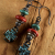 Verdigris patina cross drops with coral and turquoise from Gloria Ewing.