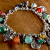 Colorful gemstones and charms, design by Gloria Ewing.