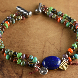 Two strand beaded bracelet with silver and gold by Gloria Ewing.