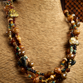 Choker length beaded design in earth tones by Gloria Ewing.
