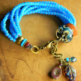 Turquoise colored multi-strand design by Gloria Ewing.
