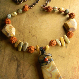 Knotted bead long necklace design by Gloria Ewing.