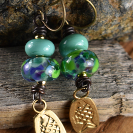 Artisan lampwork glass with fish charms by Gloria Ewing.