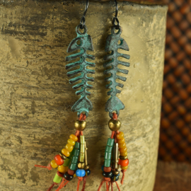 Patina fish skeleton with beaded fringe by Gloria Ewing.