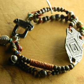 Two strand beaded bracelet by Gloria Ewing, with artisan focal.