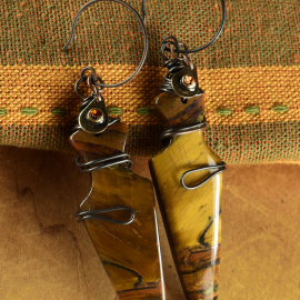 Arrowhead shaped tiger eye with wire wrap by Gloria Ewing.